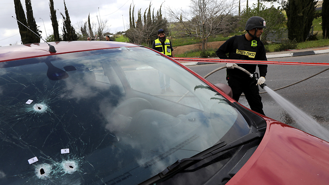 Rabbi Ettinger's car at the scene of the attack (Photo: Reuters)
