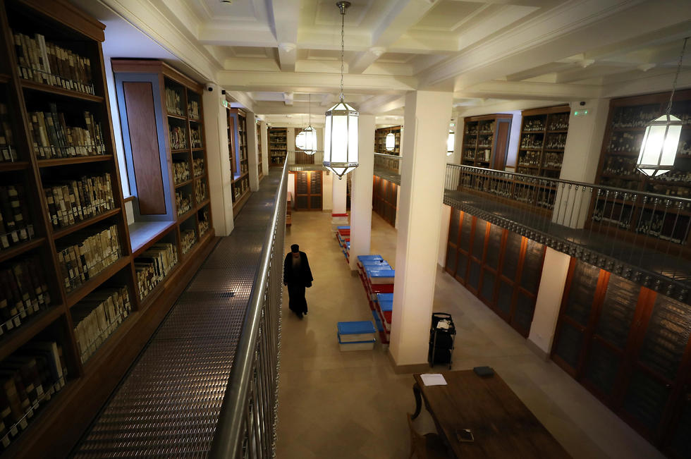 Librarian Father Justin of Sinai walks inside the library of St Catherine's Monastery in South Sinai