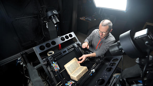 A man photographs ancient manuscript as part of a digitization process in St Catherine's Monastery