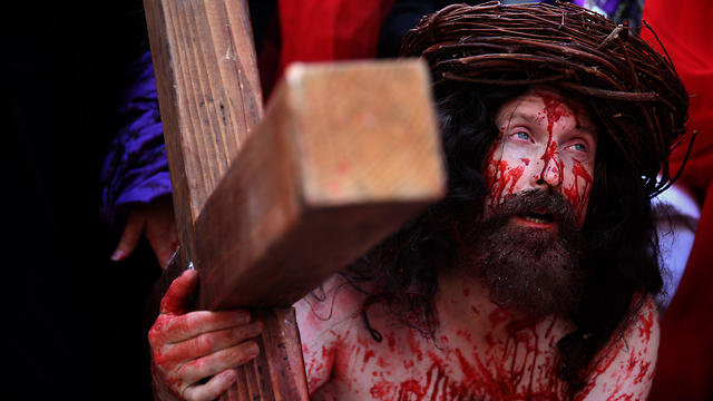 A Catholic pilgrim carries a cross along the Via Dolorosa as he re-enacts the passion of Jesus Christ on Good Friday (Photo: 