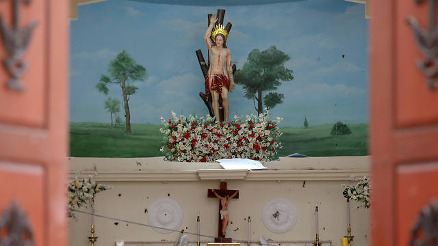 Blood stains are seen on a statue of Jesus Christ at St. Sebastian Catholic Church (Photo: Reuters)