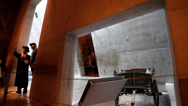 Visitors stand near an exhibit at Yad Vashem World Holocaust Remembrance Center in Jerusalem
