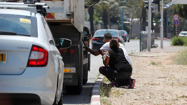 Taking cover from Gaza rocket fire in southern Israel (Photo: Reuters)