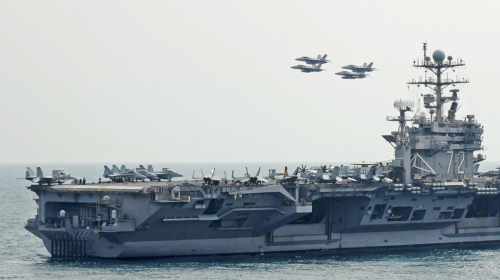 F/A 18 Superhornets flying over the USS Abraham Lincoln
