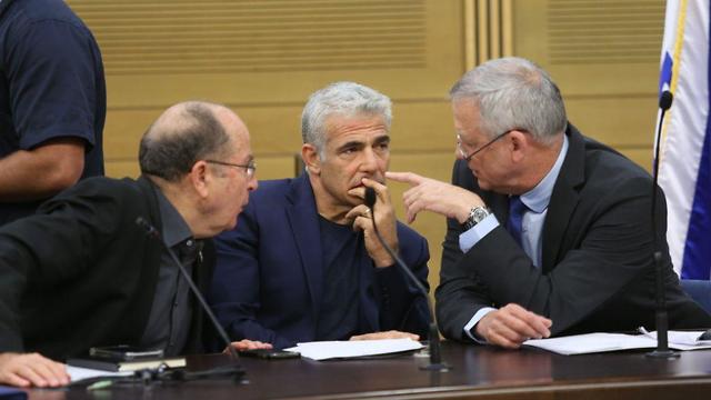 Yair Lapid alongside two other Blue and White leaders Benny Gantz and Moshe Yaâalon  (Photo: Alex Kolomoisky)