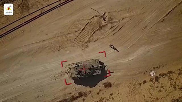 Israeli soldier walks up to a tank targeted by Islamic Jihad drone  