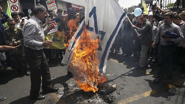 Iranian protesters burn Israeli flags during Al-Quds Day (Photo: AP)
