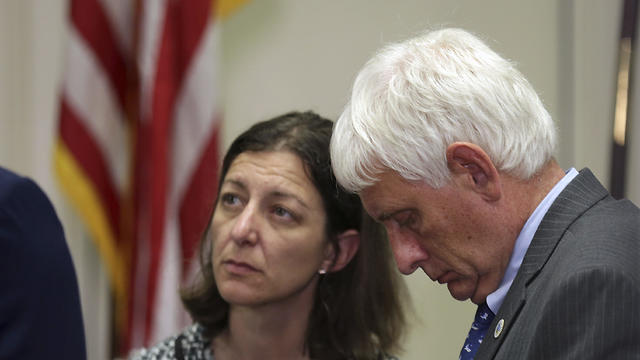 Virginia Beach Mayor Robert M. Dyer, right. talks with other city and state officials after a news conference in Virginia Beach, Va., Friday, May 31, 2019.
