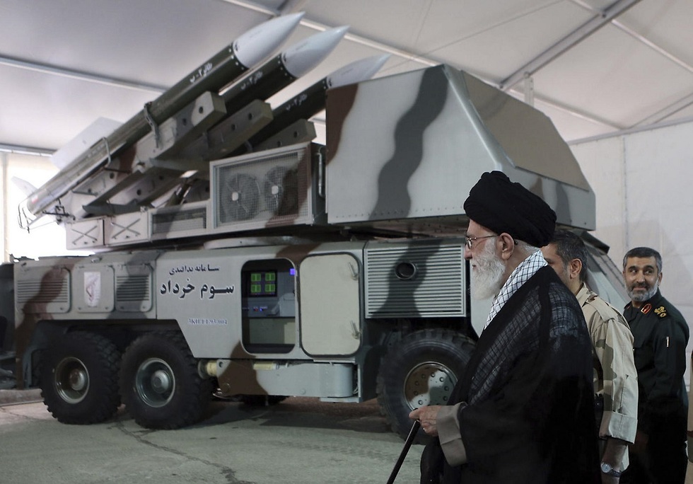 Iran's Supreme Leader Ayatollah Ali Khamenei next to an Iranian anti-aircraft missile battery