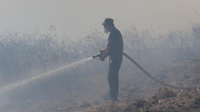 Putting out fires caused by incendiary balloons in fields near the Gaza border (Photo: Avi Roccah)