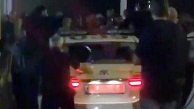 Protesters attack a police car in Netanya 