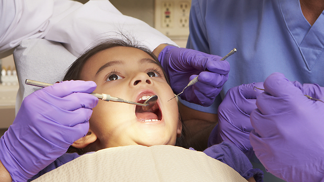 ילדה בזמן טיפול שיניים (צילום: Shutterstock)