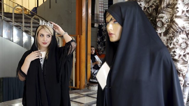 A woman tests a crown for her wedding ceremony at a market in downtown Tehran