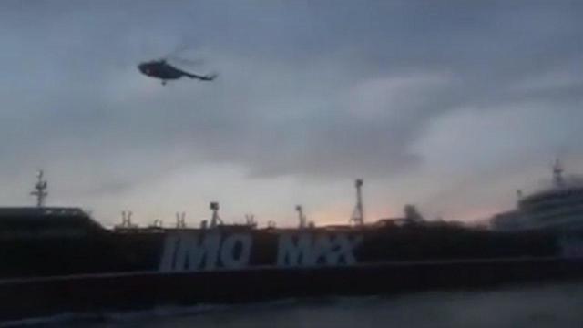 An Iranian helicopter flies over a British-flagged oil tanker in the Gulf