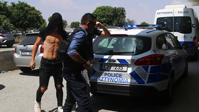 One of the suspects with the Cyprus Police (Photo: Reuters)