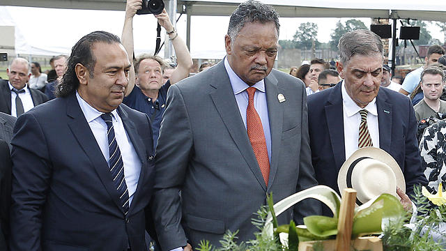 U.S. civil rights activist Jesse Jackson center, Romany activist and head of the Central Council of German Sinti and Roma Romani Rose, right, and Roma leader Roman Kwiatkowski lay flowers at the memorial site of the former Auschwitz-Birkenau German Nazi Death Camp, in Oswiecim, Poland on August 2, 2019