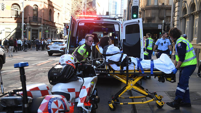 A woman wounded in the attack is taken to hospital (Photo: EPA)
