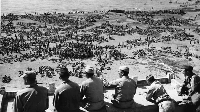Thousands of U.S. 3rd Division troops wait to board Landing Ships Tanks on an unidentified beach in Italy in preparation for Operation Dragoon, August 10, 1944