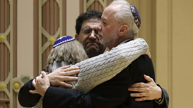Rabbi Jeffrey Myers, right, of Tree of Life/Or L'Simcha Congregation hugs Rabbi Cheryl Klein, left, of Dor Hadash Congregation and Rabbi Jonathan Perlman during a community gathering held in the aftermath of a deadly shooting at the Tree of Life Synagogue