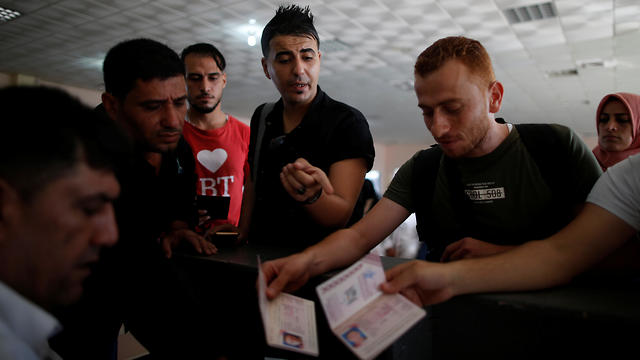 A Palestinian man gestures as he waits for a travel permit before leaving Gaza (Photo: Reuters)