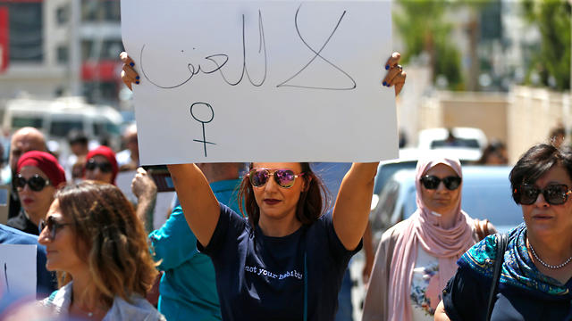 Palestinian women protest over the murder of Israa Ghrayeb outside the prime minister’s office in Ramallah on September 2, 2019. Arabic slogans on placards read: 'No to violence' 