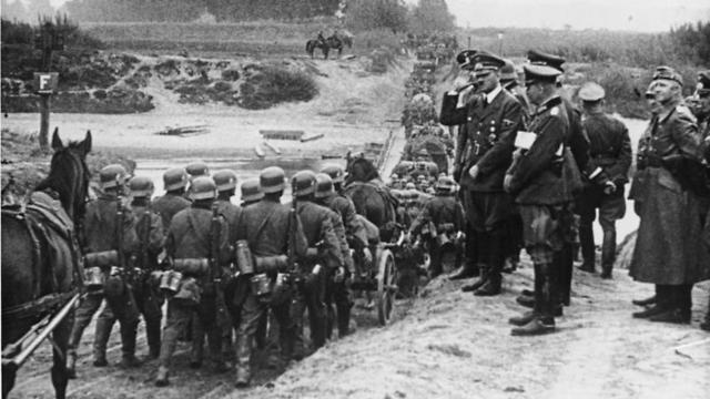 Adolf Hitler watches German soldiers marching into Poland in September 1939 