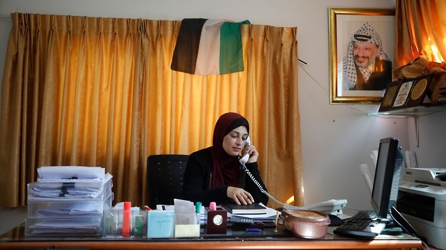 Turabe speaks on the phone as she works from her home in the village of Sarra (Photo: Reuters)