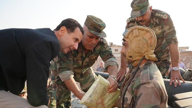 Syrian President Bashar Assad (left) visiting troops in Idlib