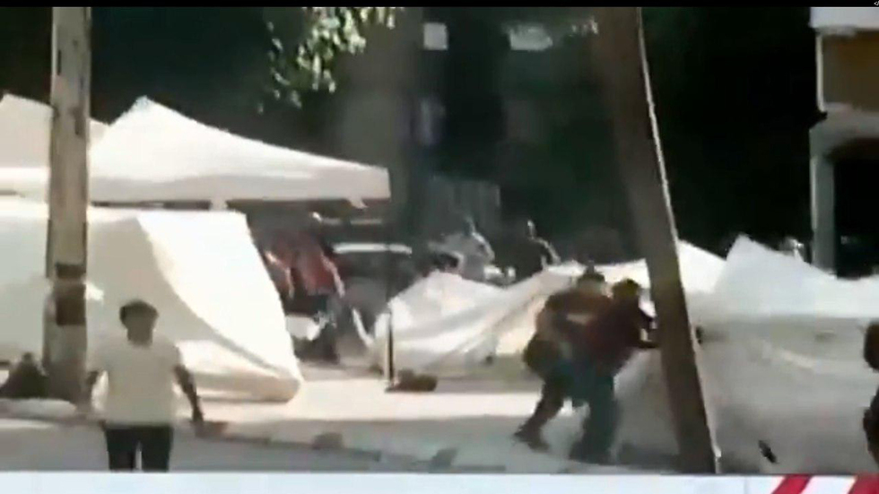 Hezbollah and Amal loyalists tear down a protest tent in Beirut 