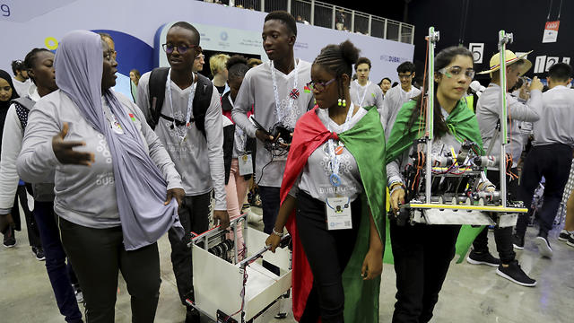 A team from Cameroon, right, competes with Luxembourg during the FIRST Global Challenge in Dubai  
