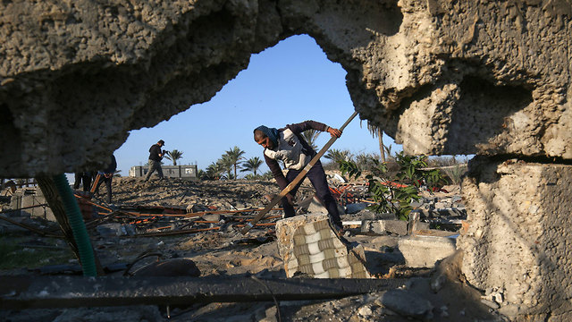 Palestinians inspect the damage after an Israeli strike (Photo: AFP)