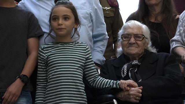Melpomeni and one of the survivor's descendants (Photo: AFP)
