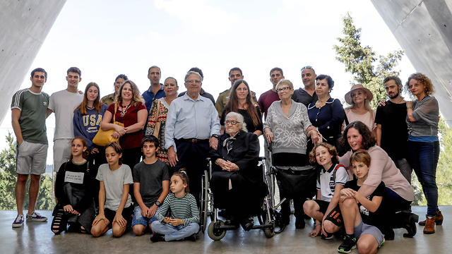 WWII rescuer in group photo with survivors and family