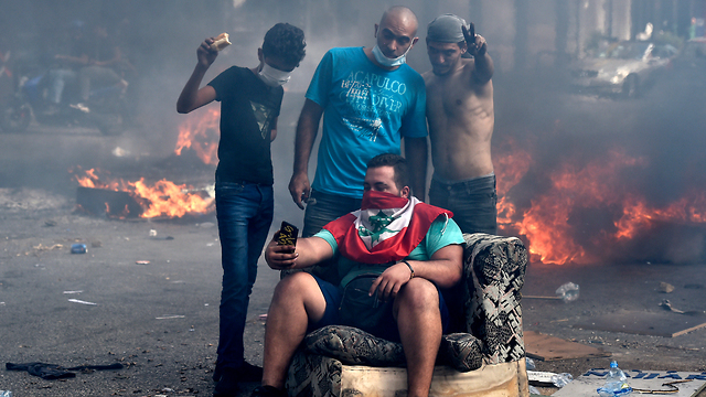 Lebanese protestors take a selfie break during riots against the government in Beirut, October (Photo: EPA)