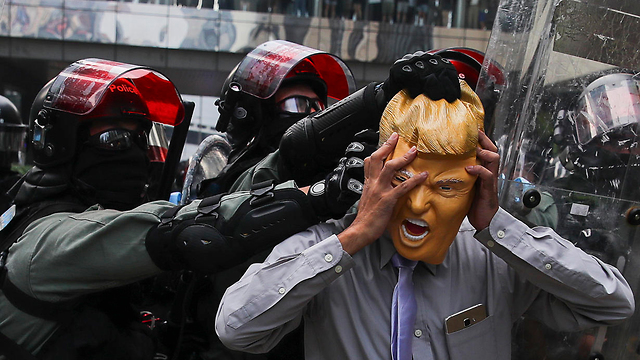 A protestor in a trump costume attacked by police during anti-government demonstrations in Hong Kong, September (Photo: EPA)