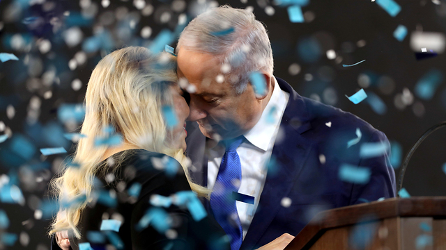 Prime Minister Benjamin Netanyahu and his wife Sara embrace after what seemed like a Netanyahu win in this year's first round of elections, April (Photo: EPA)