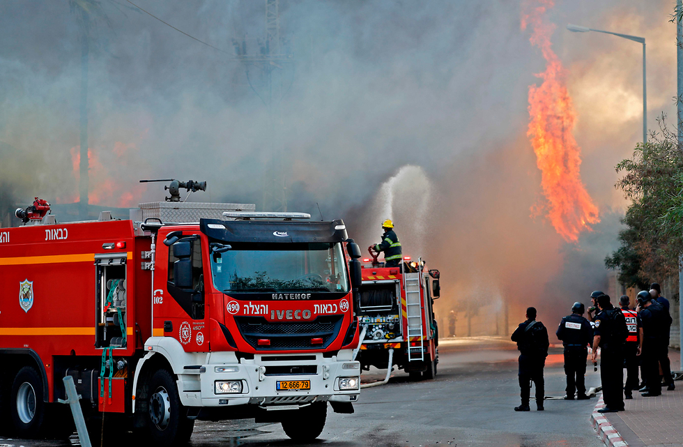 Пожарные возле горящего завода. Фото: AFP