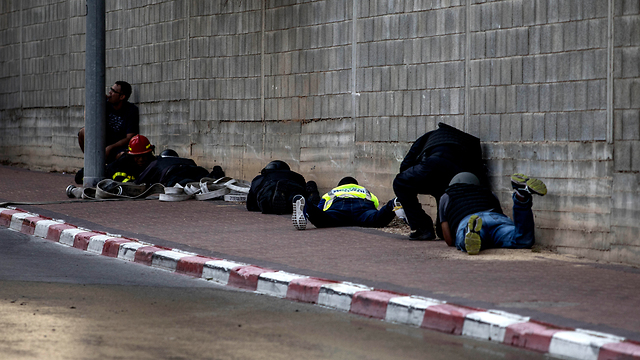 Israelis take cover from Gaza rocket fire in Sderot (Photo: AP)