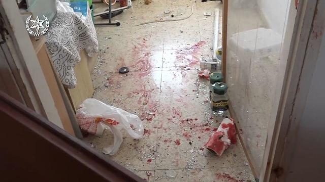 Glass shards and blood at the scene of the rocket strike on an Ashkelon assisted living facility (Photo: Police Spokeperson's Unit)