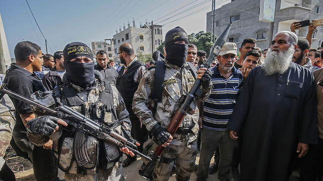 Islamic JIhad militants attend a funeral for one of the fighters killed in the two days of clashes (Photo; AFP)
