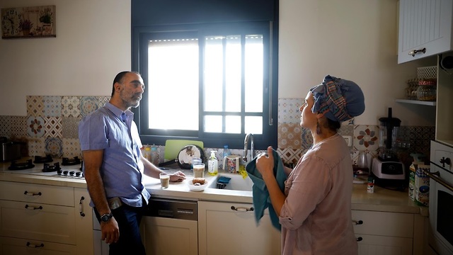 Itai Zar and Bat-Zion Zar, 41, talk in the kitchen of their home