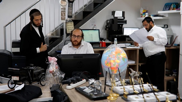 David Hamburger works in his shop in the Israeli settlement of Beitar Illit