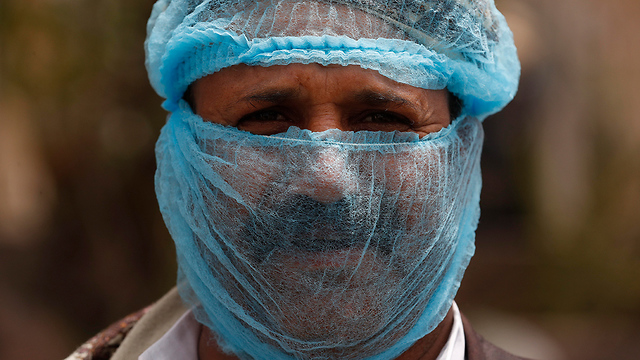 תימן מסכת פנים נגיף הקורונה מדינות בלי קורונה (צילום: EPA)