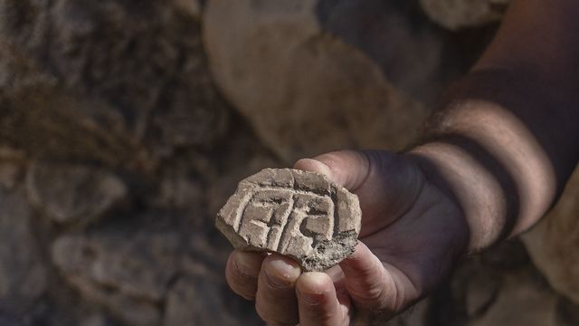 חותם עשוי שבר כלי חרס גדול מהתקופה הפרסית (צילום: שי הלוי, רשות העתיקות)