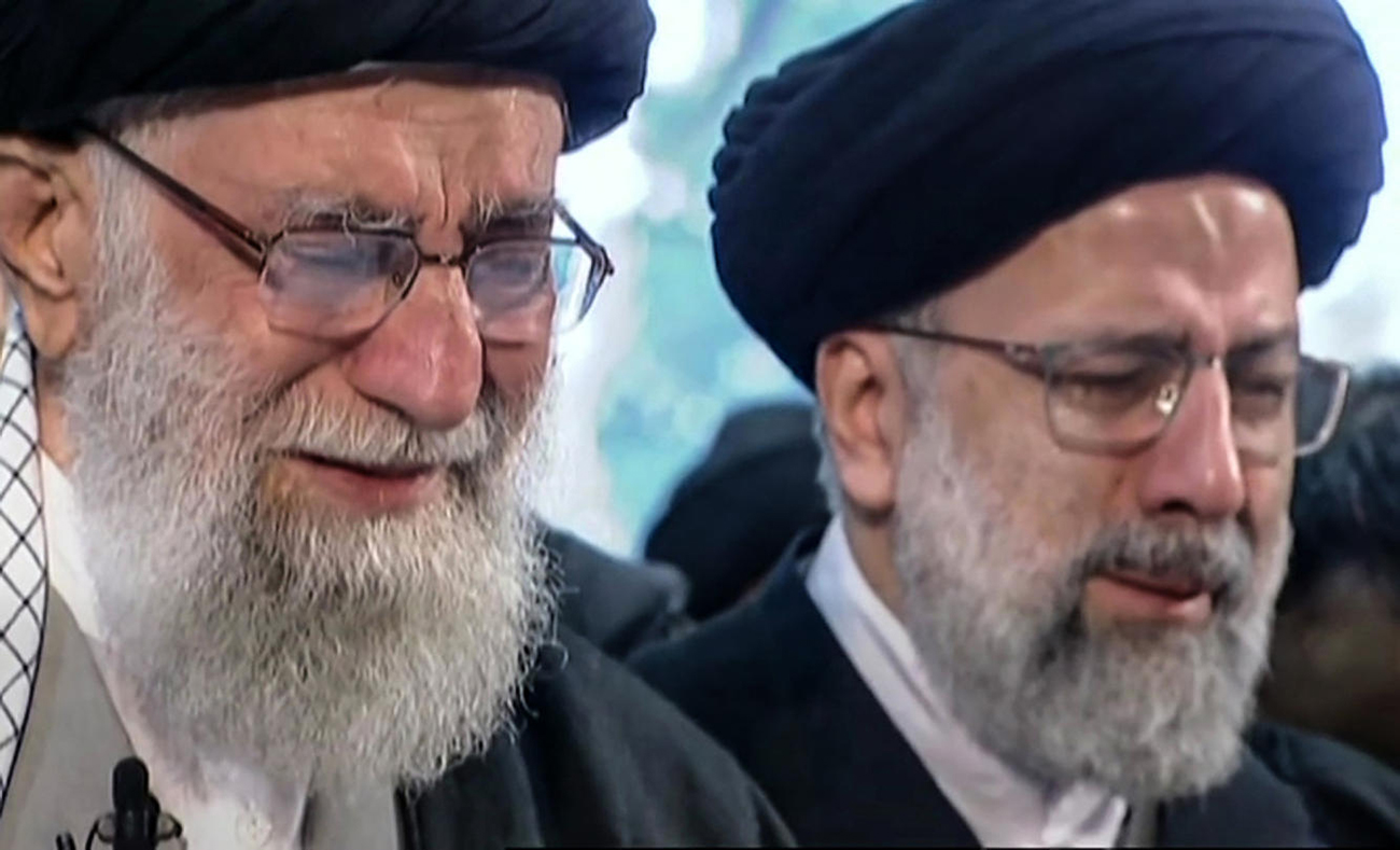 Iranian Supreme Leader Ayatollah Ali Khamenei, left, weeps at a memorial service for Qassem Soleimani in Tehran  (Photo: AFP)