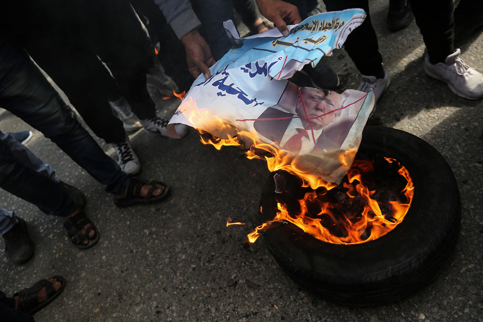 Palestinians burn an image of Donald Trump during a protest in Gaza against the U.S. peace plan  (Photo: EPA)