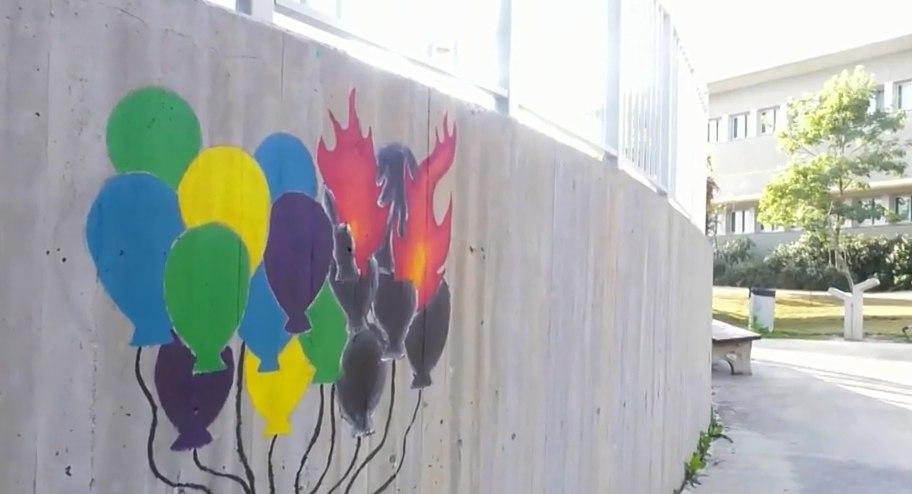 A mural of the explosive balloons sent from Gaza is painted on a school in a Gaza border community  ()
