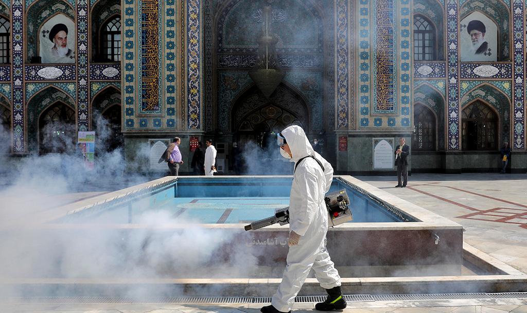 A medical worker in Iran disinfecting a Mosque in Tehran  ()