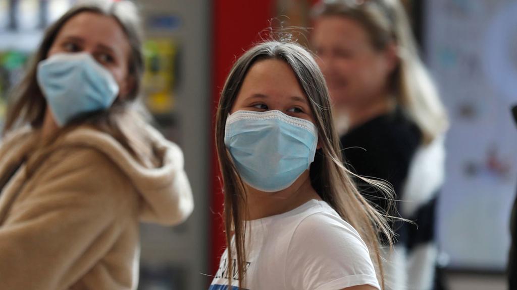 People with surgical masks at Ben Gurion Airport  ()