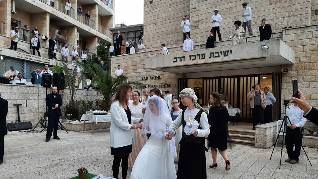 An ultra-Orthodox wedding is held at a Jerusalem yeshiva, with celebrants observing the directives to  keep their distance ()